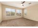 Neutral bedroom featuring a ceiling fan and multiple windows bringing in natural light at 986 W Citrus Way, Chandler, AZ 85248
