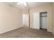 Neutral bedroom features a ceiling fan and a closet with open doors to the hallway at 986 W Citrus Way, Chandler, AZ 85248