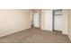 Empty bedroom with neutral walls and carpeting, sliding door closet, and open doorway to the hall at 986 W Citrus Way, Chandler, AZ 85248