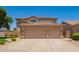 Spacious three-car garage and large driveway on tan two story home at 986 W Citrus Way, Chandler, AZ 85248