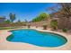 Refreshing private backyard swimming pool surrounded by desert landscaping and a fence at 986 W Citrus Way, Chandler, AZ 85248