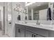 Stylish bathroom with double sinks, a large mirror, and decorative wall art at 997 E White Wing Dr, Casa Grande, AZ 85122
