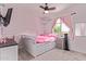 Charming bedroom with a pink theme, white furniture, and natural light at 997 E White Wing Dr, Casa Grande, AZ 85122
