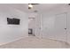 This bedroom features a ceiling fan, plush carpet and ample closet space at 997 E White Wing Dr, Casa Grande, AZ 85122