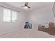 This bright bedroom features a ceiling fan and a large window for natural light at 997 E White Wing Dr, Casa Grande, AZ 85122