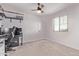 This carpeted bedroom features a ceiling fan and a window for natural light at 997 E White Wing Dr, Casa Grande, AZ 85122