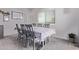Bright dining room featuring a table with six chairs, modern flooring and a large window at 997 E White Wing Dr, Casa Grande, AZ 85122