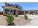 Inviting two-story home with desert landscaping, a wide driveway, and attractive architectural details at 997 E White Wing Dr, Casa Grande, AZ 85122