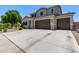 Two-story home with desert landscaping, a wide driveway, and a welcoming facade at 997 E White Wing Dr, Casa Grande, AZ 85122