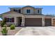 Two-story home featuring a two-car garage, desert landscaping and neutral color palette at 997 E White Wing Dr, Casa Grande, AZ 85122