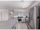 Modern kitchen with gray cabinets, stainless steel appliances, and granite countertops at 997 E White Wing Dr, Casa Grande, AZ 85122