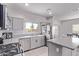 Well-lit kitchen with stainless appliances, ample countertop space, and gray cabinetry at 997 E White Wing Dr, Casa Grande, AZ 85122