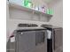 Well-organized laundry room featuring new front loading washer and dryer and ample shelf storage at 997 E White Wing Dr, Casa Grande, AZ 85122