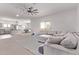 Open-concept living room with a sectional sofa, and views of the kitchen and dining area at 997 E White Wing Dr, Casa Grande, AZ 85122