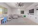 Spacious living room with a large sectional sofa, ceiling fan, and built-in shelves at 997 E White Wing Dr, Casa Grande, AZ 85122