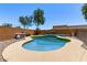 Backyard pool area with rock border and privacy fencing, perfect for summer fun at 997 E White Wing Dr, Casa Grande, AZ 85122