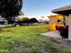 Scenic backyard view showcasing a patio set, lush greenery, and neighboring houses at 10726 W Kelso Dr, Sun City, AZ 85351