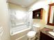 Bathroom features bathtub with shower, storage, granite vanity, toilet, and tiled floor at 10726 W Kelso Dr, Sun City, AZ 85351