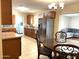 Well-lit kitchen featuring stainless steel appliances, a dining area, and granite countertops at 10726 W Kelso Dr, Sun City, AZ 85351