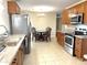 Modern kitchen featuring stainless steel appliances, granite countertops, and dining area at 10726 W Kelso Dr, Sun City, AZ 85351