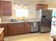 Bright kitchen with granite countertops, stainless steel appliances, and custom cabinetry at 10726 W Kelso Dr, Sun City, AZ 85351