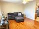 Inviting living room featuring laminate floors, a ceiling fan, and comfortable gray sofa at 10726 W Kelso Dr, Sun City, AZ 85351