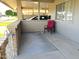 Comfortable patio space featuring brick pillars, iron railing, and a red chair at 10726 W Kelso Dr, Sun City, AZ 85351