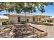 Exterior view of a home showing a landscaped backyard and covered patio at 11033 E Keats Ave, Mesa, AZ 85209