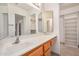 Bathroom features a large mirror, white countertops and wood cabinets with tiled floors at 11033 E Keats Ave, Mesa, AZ 85209