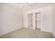 Bright bedroom features a ceiling fan and a closet ready to be personalized at 11033 E Keats Ave, Mesa, AZ 85209