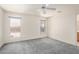 Cozy bedroom featuring plush carpeting, two sunlit windows and neutral-toned walls at 11033 E Keats Ave, Mesa, AZ 85209