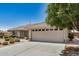 Angle view of a single-story home with desert landscaping, a two-car garage, and a neutral exterior at 11033 E Keats Ave, Mesa, AZ 85209