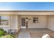 Close up of the front of a home with an ornate storm door, neutral color palette, and desert landscaping at 11033 E Keats Ave, Mesa, AZ 85209