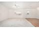 Bright, neutral living room features both carpeted and hard surface flooring, natural light and a ceiling fan at 11033 E Keats Ave, Mesa, AZ 85209