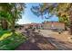 The vast backyard has many mature trees, grassy areas, seating, and paved areas at 11143 E Vallejo St, Chandler, AZ 85248