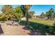 Spacious backyard with a patio, furniture, detached garage, and lush greenery at 11143 E Vallejo St, Chandler, AZ 85248