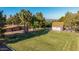 Expansive backyard featuring a large grass area with lush landscaping and a detached garage at 11143 E Vallejo St, Chandler, AZ 85248