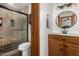Well-lit bathroom with a glass-enclosed shower, vanity and updated fixtures at 11143 E Vallejo St, Chandler, AZ 85248