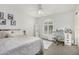 Bedroom featuring white walls, arched window, desk area, and a comfortable bed at 11143 E Vallejo St, Chandler, AZ 85248