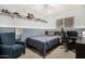 Cozy bedroom with blue accent walls, shelves, a comfortable armchair, and a ceiling fan at 11143 E Vallejo St, Chandler, AZ 85248