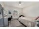 Well-lit bedroom with white walls, an arched window, and a desk area for study at 11143 E Vallejo St, Chandler, AZ 85248