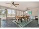 The dining area has large windows, lots of space, tile flooring, and ceiling fans at 11143 E Vallejo St, Chandler, AZ 85248