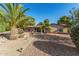 Charming single-story home with desert landscaping, mature palms, and pathway to the front door at 11143 E Vallejo St, Chandler, AZ 85248