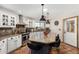 Charming kitchen featuring a large island, granite countertops, and designer pendant lighting at 11143 E Vallejo St, Chandler, AZ 85248