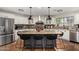 Modern kitchen with a large center island, stainless steel appliances and granite countertops at 11143 E Vallejo St, Chandler, AZ 85248
