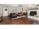 Inviting living room with hardwood floors, a fireplace, and comfortable seating at 11143 E Vallejo St, Chandler, AZ 85248