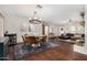 Open-concept living room and dining area with hardwood floors and neutral paint at 11143 E Vallejo St, Chandler, AZ 85248