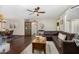 Comfortable living room with a large sectional sofa and modern ceiling fan at 11143 E Vallejo St, Chandler, AZ 85248