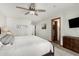 Comfortable main bedroom with a ceiling fan and views of the en-suite bathroom at 11143 E Vallejo St, Chandler, AZ 85248