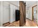 Mud room featuring terracotta tile, closet with bi-fold doors, and a sliding barn door at 11143 E Vallejo St, Chandler, AZ 85248